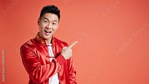 Smiling Asian man in traditional red attire gesturing happily