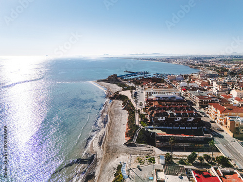 Aerial view of Torre de la Horadada townscape with Mediterranean Sea view during sunny day. Spanish resort, travel and touristic places concept. Costa Blanca, Alicante province, Spain 