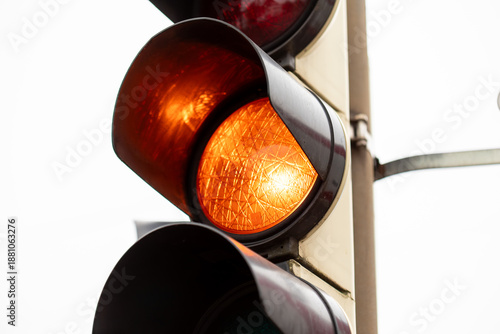Quadro em tela Yellow traffic light illuminating street intersection caution signal