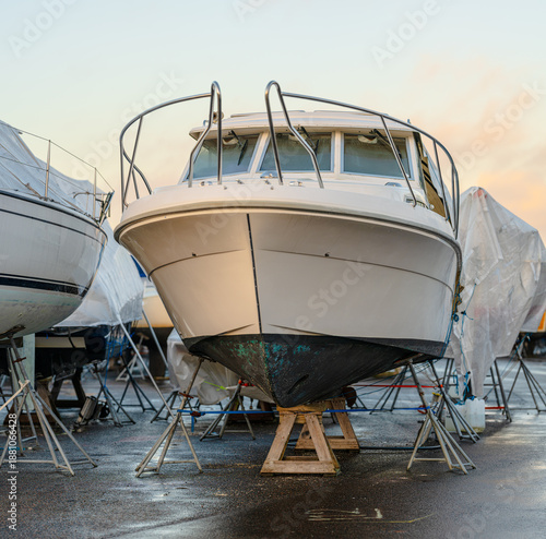 Fényképezés Motorboat on supports stored ashore during winter season.