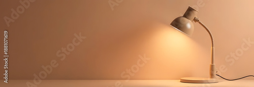 Desk lamp on beige background, warm light minimalist workspace with copy space