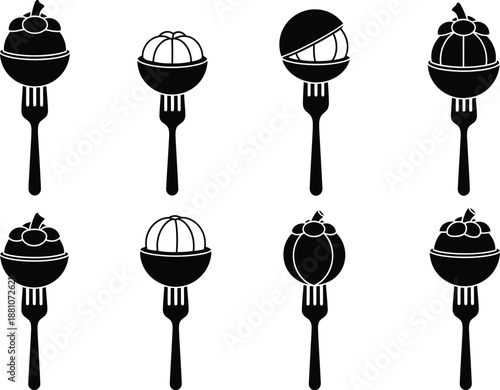 Mangosteen fruit displayed on eating forks shows tropical food.