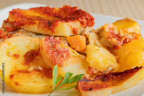 Traditional Greek moussaka slice with minced meat and potato layers.