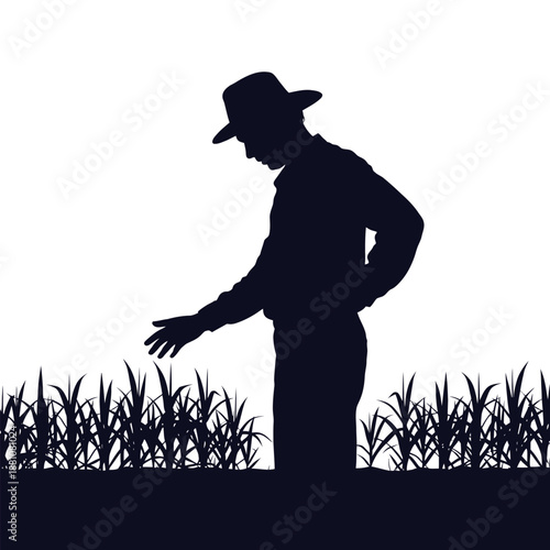 Silhouette of a farmer man standing in a field