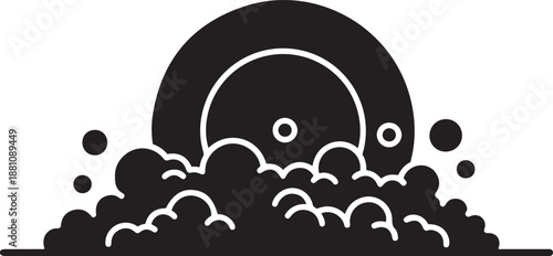 Black and white of a plate being washed in soapy water with bubbles dishwashing cleaning