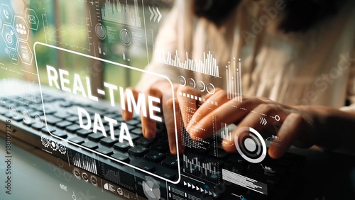 Hands Typing on Keyboard with Digital Overlays of Real-Time Data Visualization Concepts and Analytics. Asymptotic smart data analytic. © InfiniteFlow