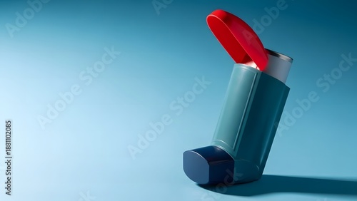 A red and gray inhaler on a blue background for asthma treatment and medication purposes
