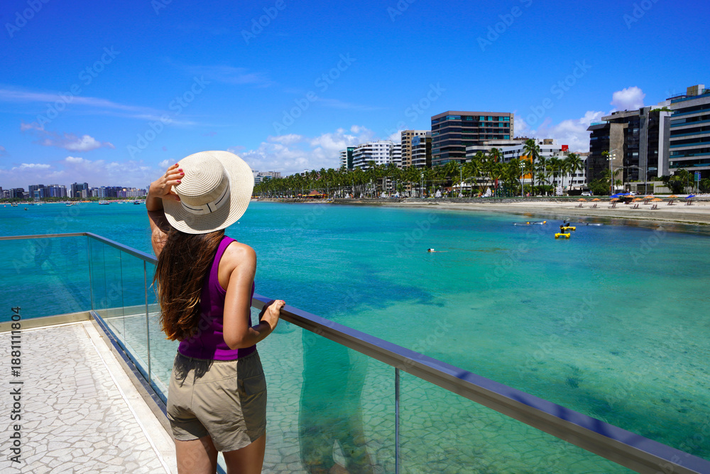 Obraz premium Holidays in Brazil. Young woman walking on promendae in Maceio, Alagoas, Brazil.