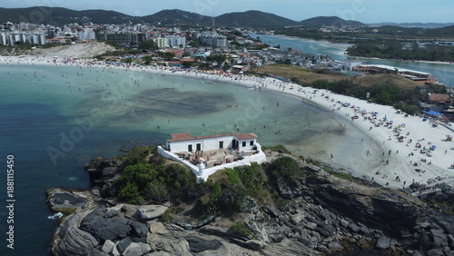 Aerial view of Cabo Frio coastline featuring a historic fort on rocky cliffs, turquoise waters and sandy beaches. Popular travel destination in Rio de Janeiro, Brazil.