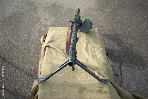 A machine gun for firing. Military weapons standing on the ground. Machine gun on the street.