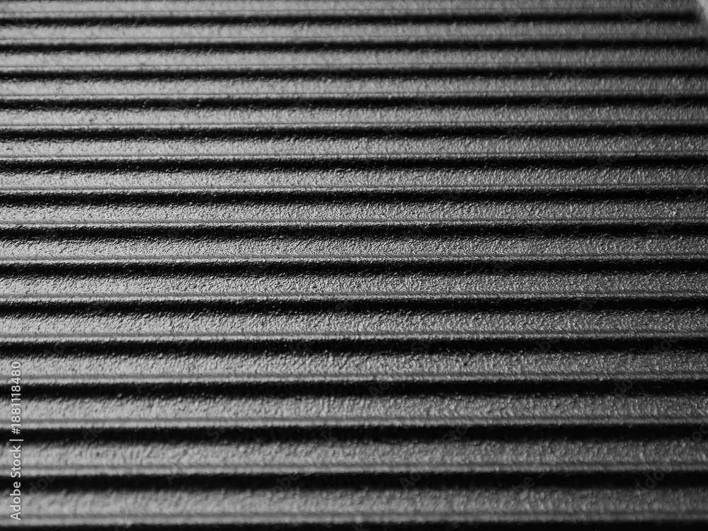 Obraz premium Cast iron frying pan surface with ridges for cooking meat and vegetables.