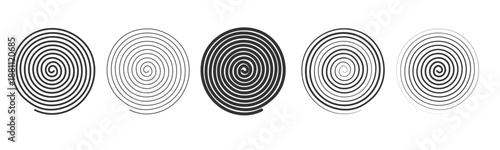 Different spiral patterns on a flat surface showing a variety of designs from dark to light in a simple arrangement