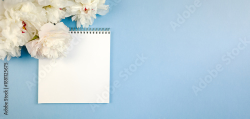 Obraz na plátne elegant floral stationery, spiral notebook surrounded by delicate peony flowers