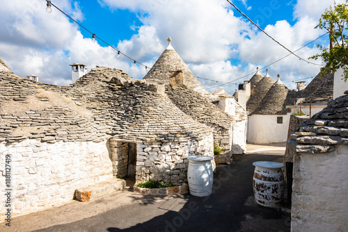 Wallpaper Mural Cluster of ancient trulli under string lights, showcasing Alberobello’s timeless charm, Apulia, Italy Torontodigital.ca
