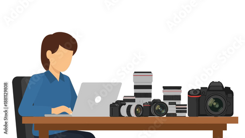 Photographer working with laptop and camera equipment on desk