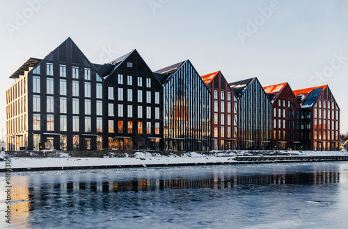 Cold winter day in Elblag, modern houses on the riverbank