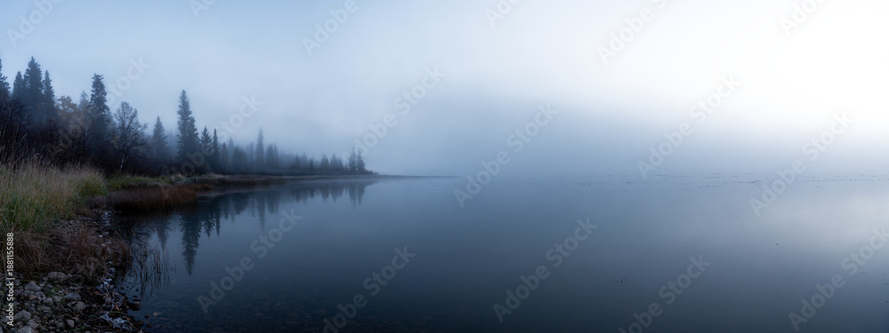 Fototapeta premium Panorama of a foggy morning at a northern lake with the sky fading to transparent 