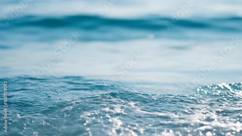 Close-up shot of a small wave in the ocean, creating a serene and calming scene.