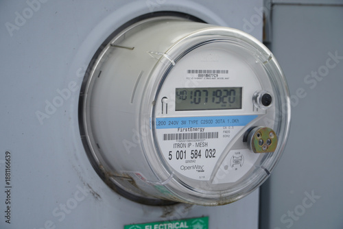 Schilderij op canvas Digital smart electric meter mounted on an exterior wall of a building for residential energy monitoring and utility billing services