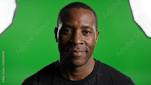 Focused Portrait of a Person Smiling in Studio with Green Screen and Soft Lighting for Media Content