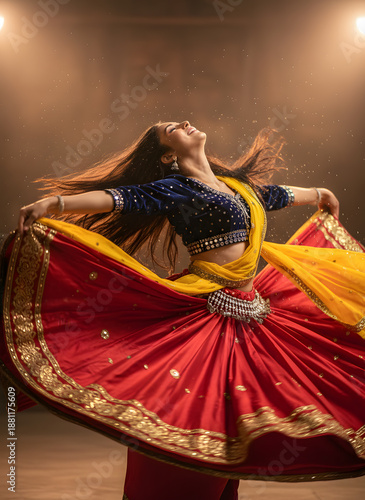 Dynamic motion of a woman in traditional dress spinning in a spotlight