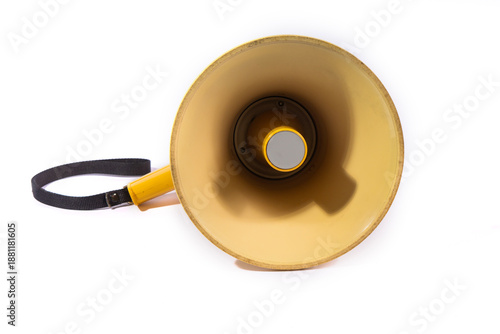 Yellow megaphone or bullhorn isolated on a white background. A portable loudspeaker with a black strap used for announcements, protests, and directing crowds