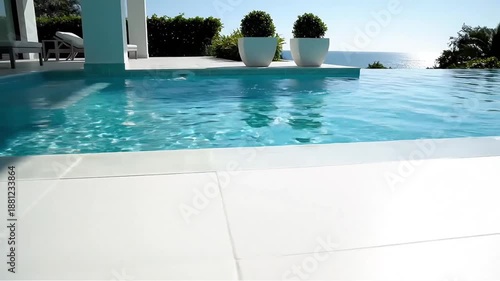 Luxurious infinity pool overlooking a turquoise ocean with modern architecture and lush greenery a serene escape embodying high-end coastal living and relaxation