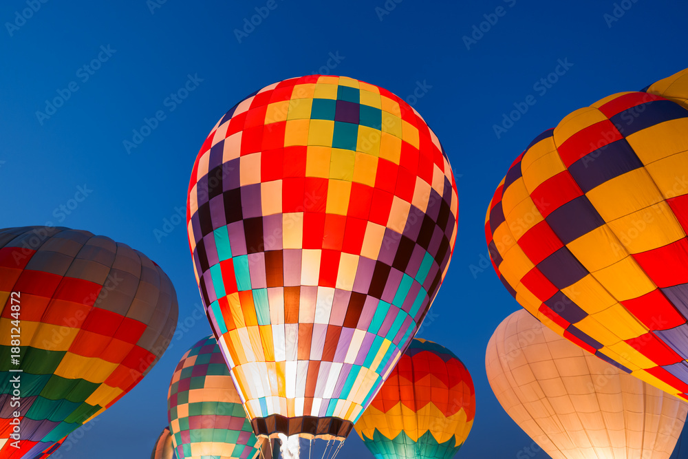 Fototapeta premium colorful hot air balloons glowing against sky