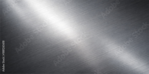 Polished silver stainless steel plate with a brushed metal texture and shiny aluminum surface featuring light grey reflections on an industrial metallic sheet material