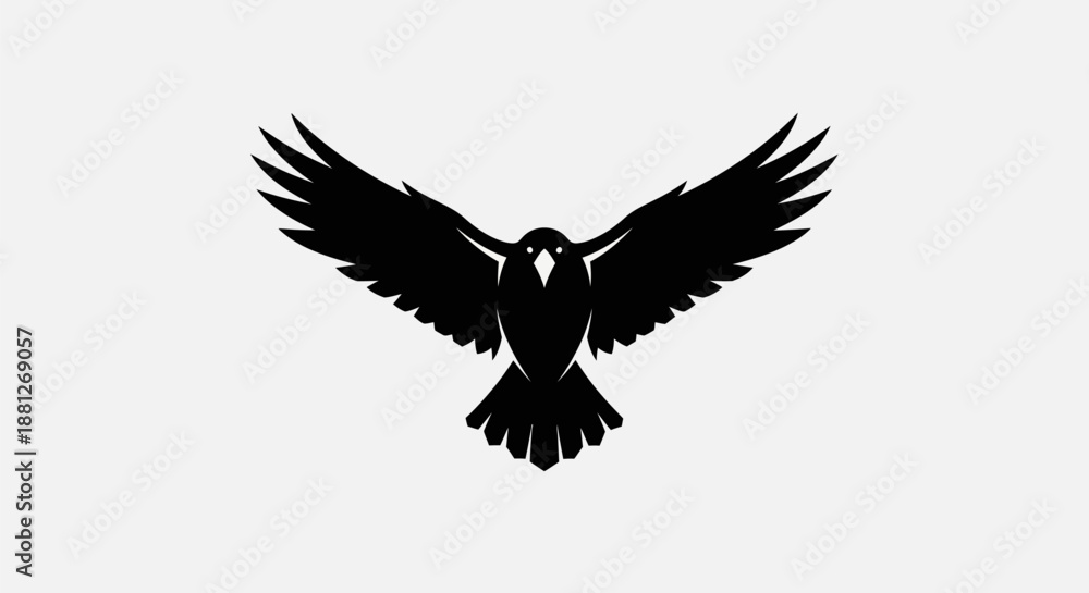 Fototapeta premium Black bird silhouette with wings spread against white background
