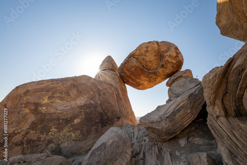 Sun Burst Over Balanced Rock On Blue Sky Day