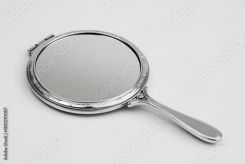 Elegant handheld mirror with ornate silver frame and handle