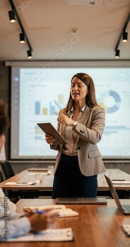 Woman presenting in office with presentation screen business concept
