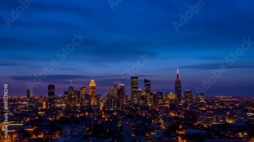 Wallpaper Mural Dusk view of a sprawling city skyline, illuminated lights against a colorful sky Torontodigital.ca