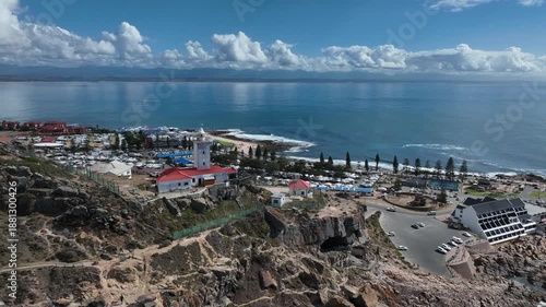 Sunny aerial orbits Cape St Blaize lighthouse at Mossel Bay in RSA