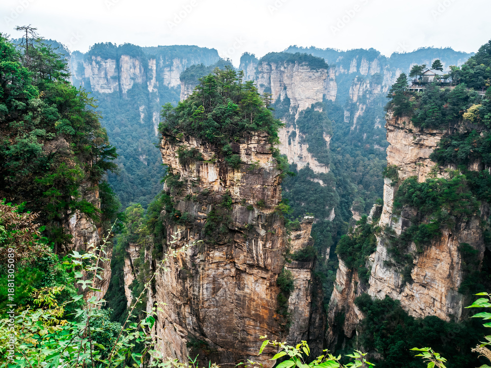 Naklejka premium Majestic sandstone pillars of Zhangjiajie National Forest Park, famously known as the Avatar Mountains. This breathtaking landscape inspired the floating mountains in the famous movie.