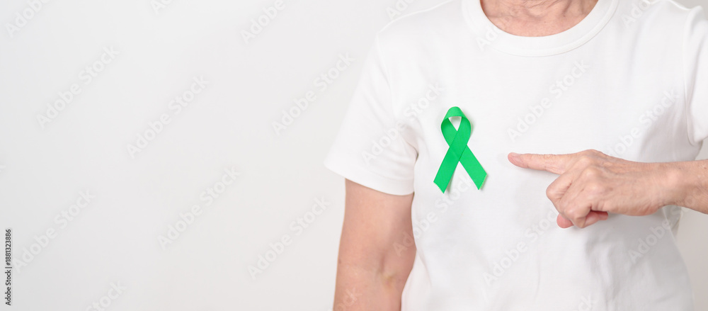 Naklejka premium Elderly with Green Ribbon for concept of March world Bipolar disorder day, Cerebral Palsy Awareness month, kidney disease Cancer and Traumatic Brain Injury, TBI. Healthcare and world cancer day