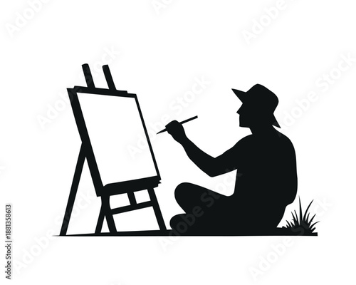 Silhouette of an artist painting on a canvas outdoors, sitting cross-legged in the grass