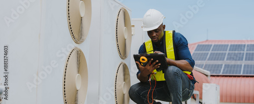 Engineers are checking the air conditioning and cooling system in a commercial building.(PHOTO)