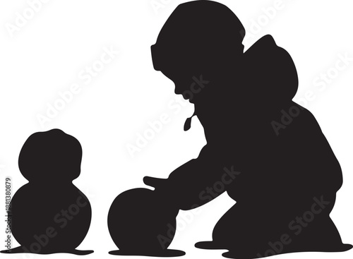 Silhouette of a person and a child building a snowman