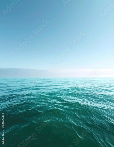 Calm teal water meets blue horizon