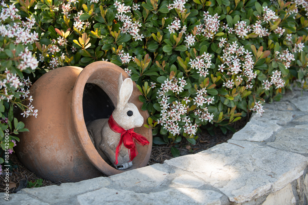 Fototapeta premium Rabbit easter garden decor. Rabbit cute holiday decoration. Rabbit spring festive symbol. Rabbit playful seasonal ornament.