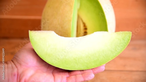 Closeup to Fresh green melon on wood plate