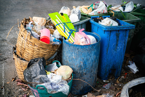 Принти на полотні Overflowing Garbage Bins with Plastic Waste on Urban Street
