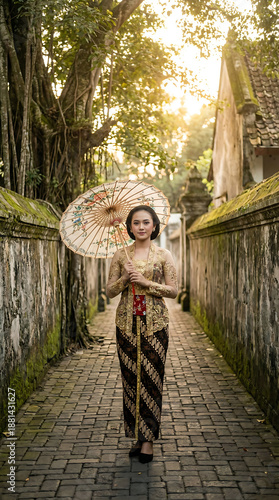 Javanese Woman in Elegant Kebaya with Umbrella in Village Alley