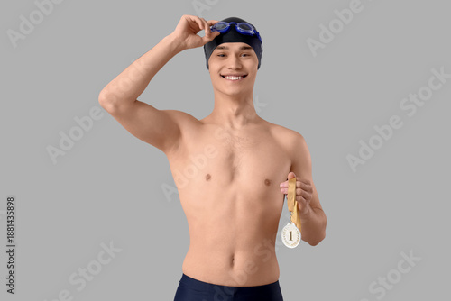Young male swimmer with fir...