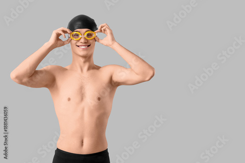 Young male swimmer with gog...