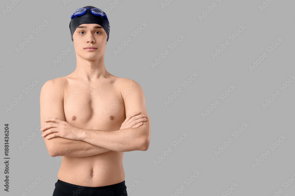 Obraz premium Young male swimmer on light background