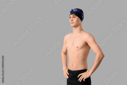 Young male swimmer on light...