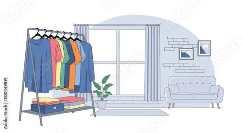 Modern living room interior features a clothing rack full of colorful t-shirts next to a large window and a comfortable grey sofa chair.